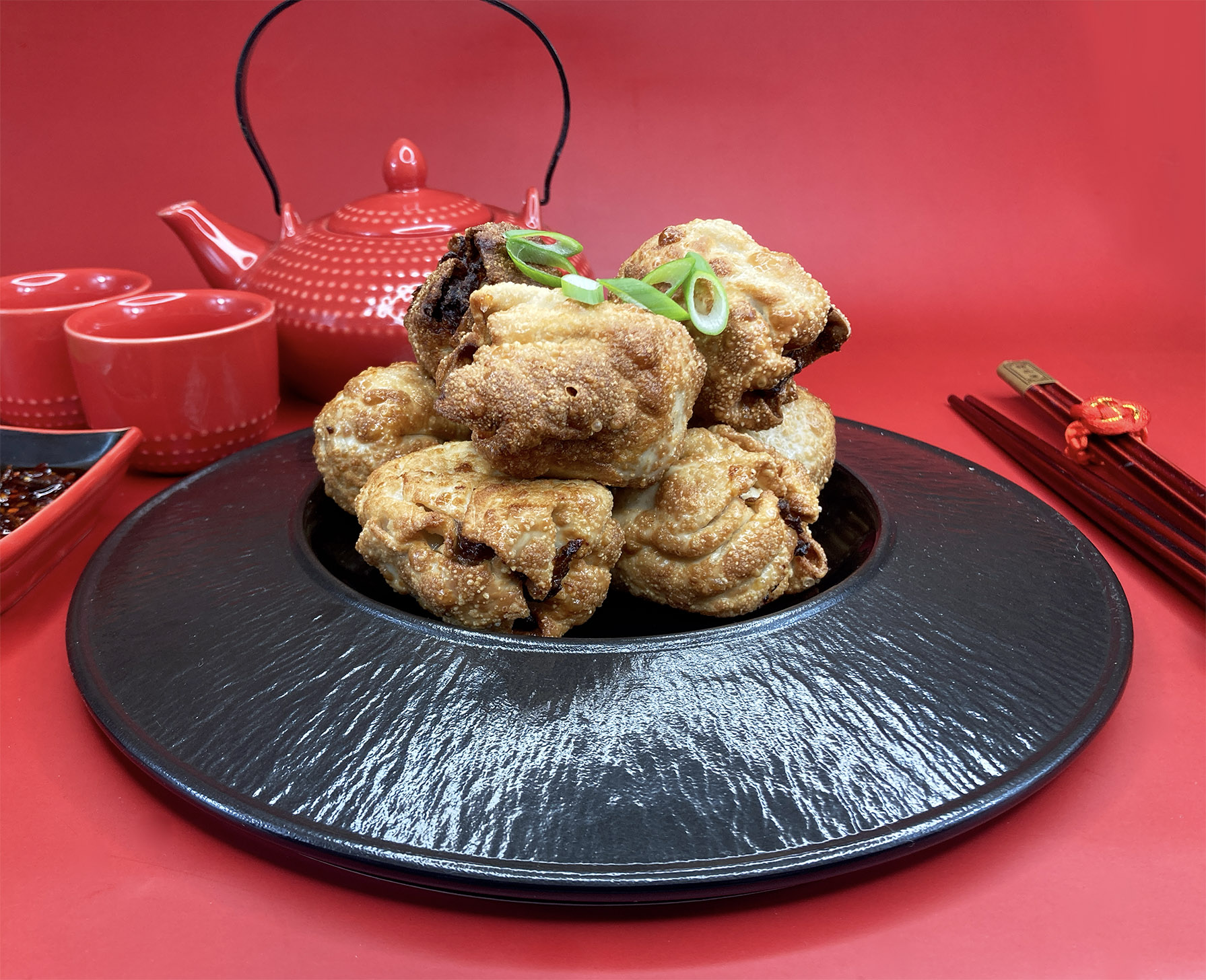 Crispy Moon Palace dim sims fresh from the fryer on a bamboo tray